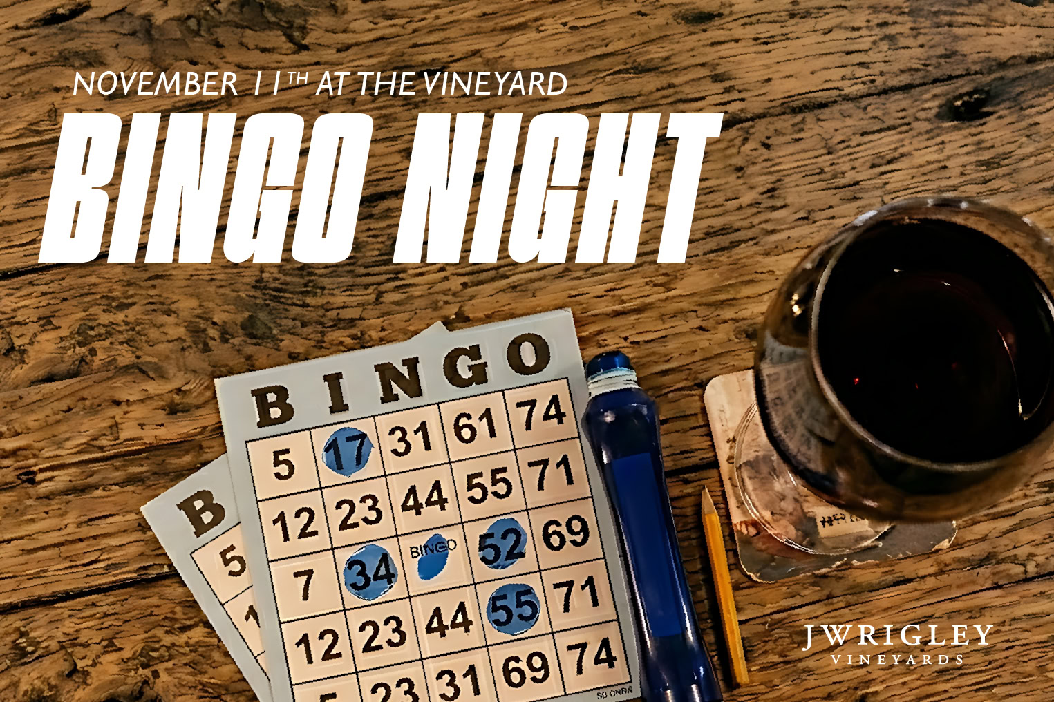 Bingo cards and a glass of red wine at J Wrigley Vineyards during Bingo Night event.