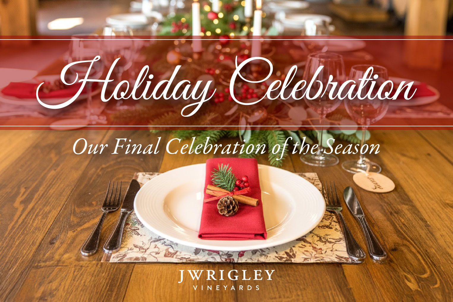 Holiday celebration table setting with a red napkin, pine cone, and festive decor at J Wrigley Vineyards.